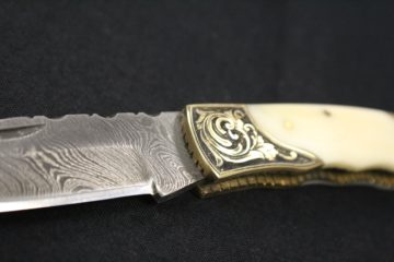 Damascus blade, bone and brass handle.